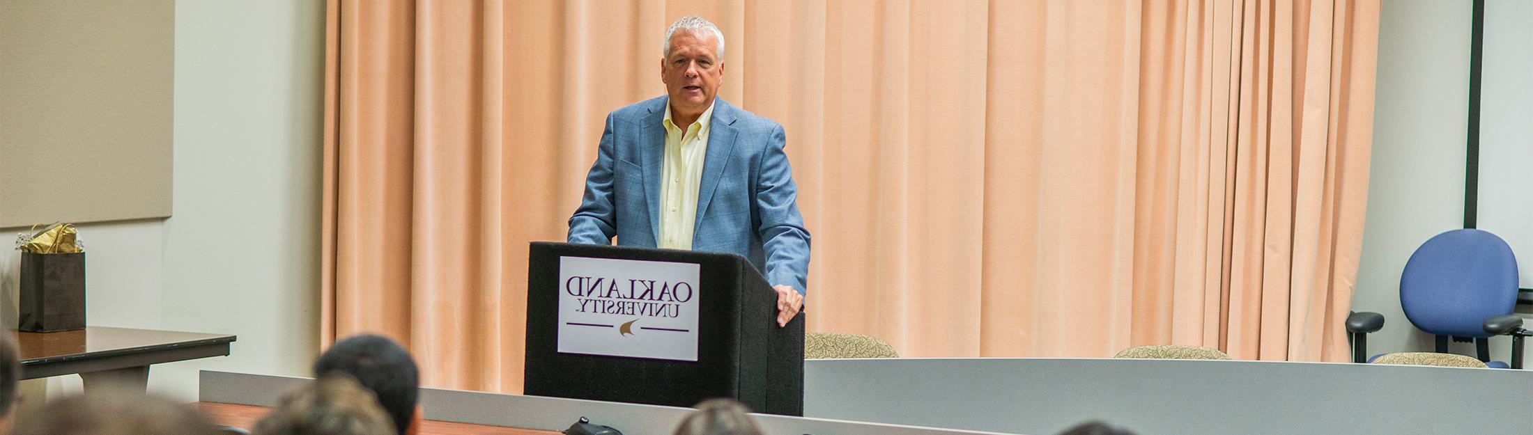 A man lecturing at a podium